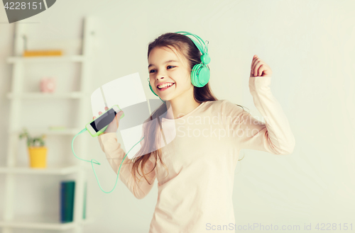 Image of girl with smartphone and headphones at home