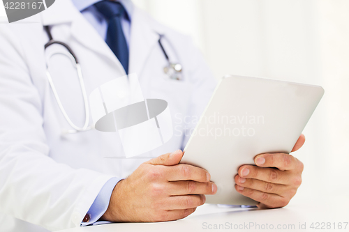 Image of male doctor in white coat with tablet pc