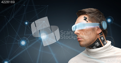 Image of man in virtual reality glasses and microchip