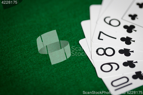 Image of poker hand of playing cards on green casino cloth