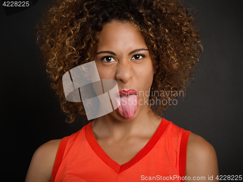 Image of Beautiful woman pulling her tongue out