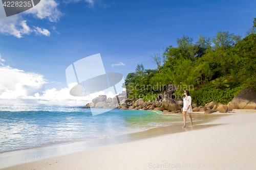 Image of A beautiful woman walking on the beach