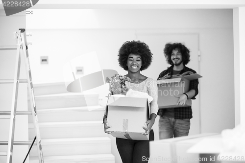 Image of multiethnic couple moving into a new home