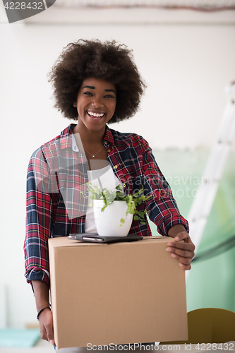 Image of Black girl moving in the new apartment