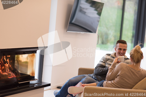 Image of Young couple  in front of fireplace