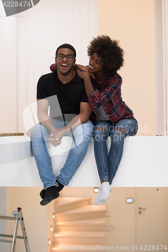 Image of couple having break during moving to new house