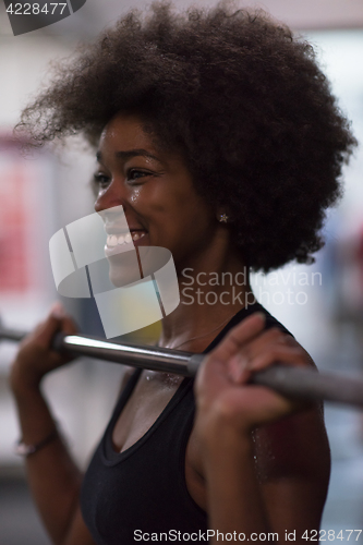 Image of black woman lifting empty bar