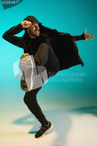 Image of The silhouette of one hip hop male break dancer dancing on colorful background