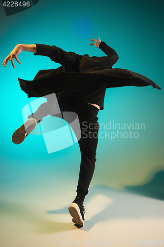 Image of The silhouette of one hip hop male break dancer dancing on colorful background