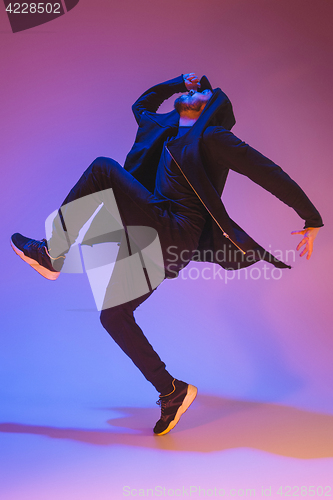 Image of The silhouette of one hip hop male break dancer dancing on colorful background