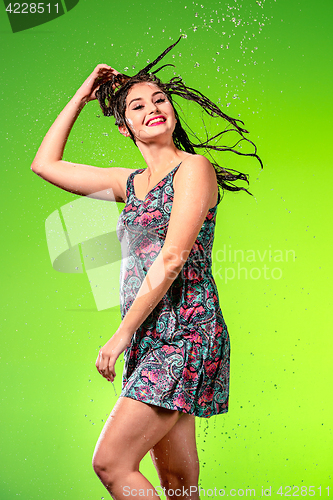 Image of Young beautiful woman under splash of rain