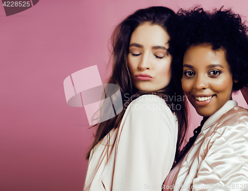 Image of different nation girls with diversuty in skin, hair. Asian, scandinavian, african american cheerful emotional posing on pink background, woman day celebration, lifestyle people concept 