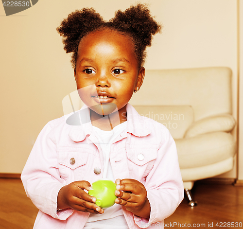 Image of little cute african american girl playing with animal toys at ho