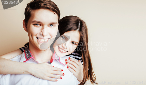 Image of young pretty teenage couple, hipster guy with his girlfriend happy smiling and hugging isolated on white background, lifestyle people concept 