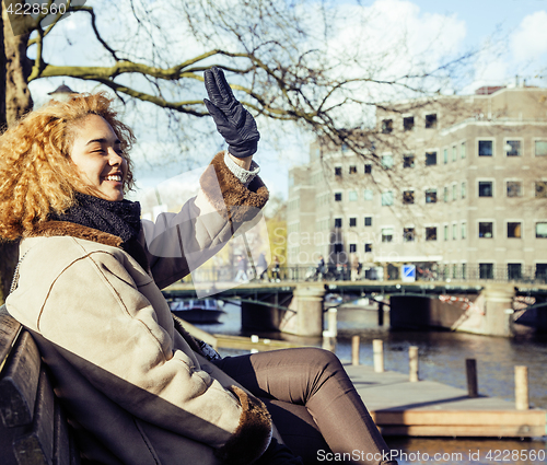 Image of young cute blond african american girl student holding tablet and smiling, lifestyle people concept 