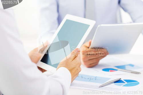 Image of businesswomen with tablet pc and charts at office