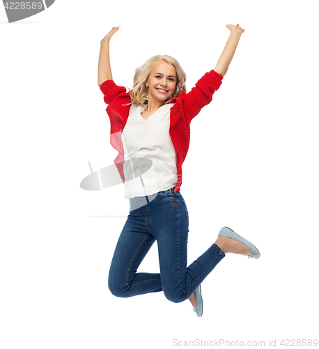 Image of smiling young woman jumping in air