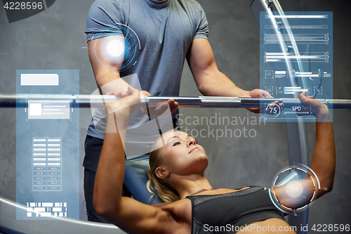 Image of man and woman with barbell flexing muscles in gym