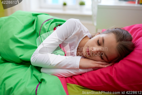 Image of girl sleeping in her bed at home