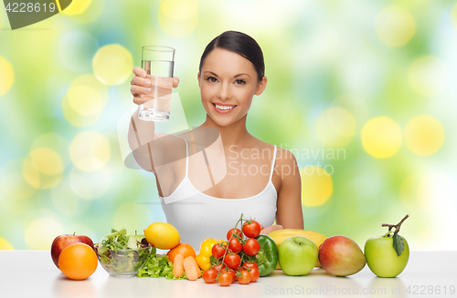 Image of happy woman with glass of water and healthy food