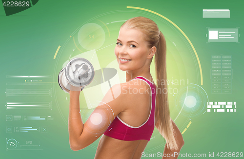 Image of happy sporty woman with dumbbell flexing biceps