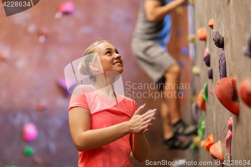 Image of man and woman exercising at indoor climbing gym