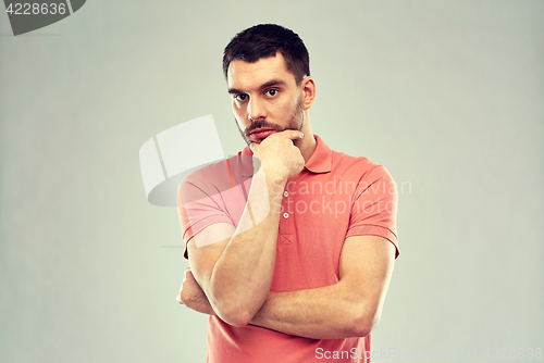 Image of man thinking over gray background