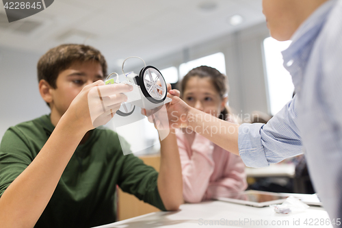 Image of happy children building robots at robotics school