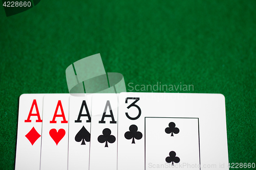 Image of poker hand of playing cards on green casino cloth