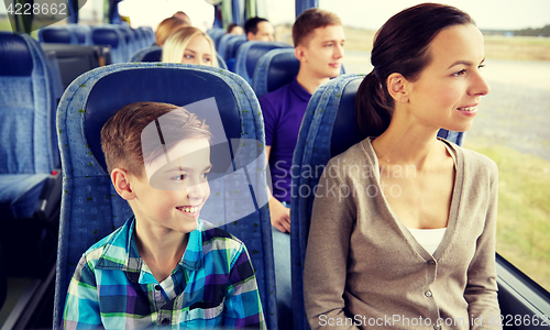 Image of happy family riding in travel bus