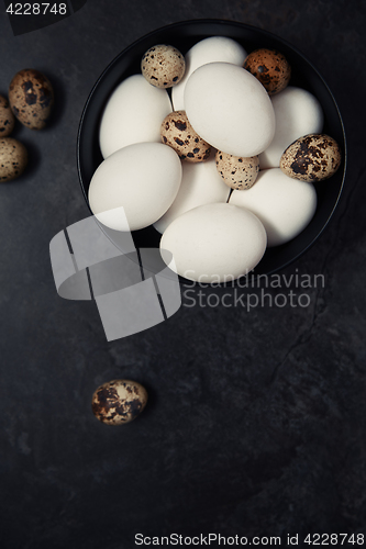 Image of Quail and chicken eggs on a table