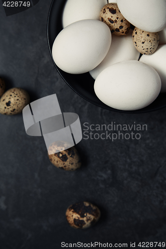 Image of Quail and chicken eggs on a table