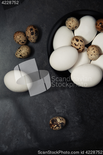 Image of Quail and chicken eggs on a table