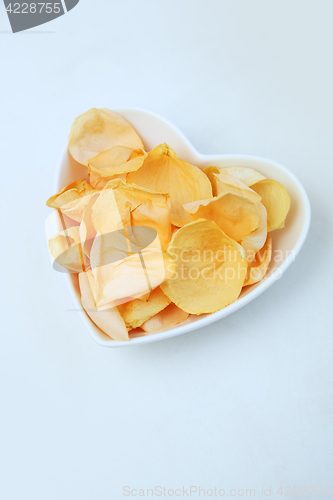 Image of Rose petals in heart shaped bowl