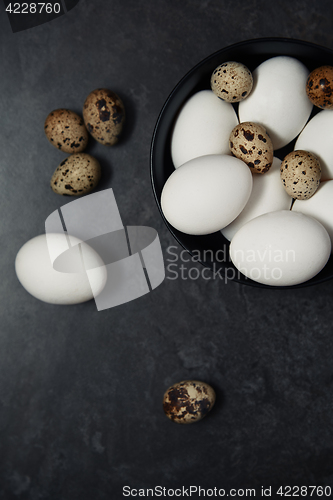 Image of Quail and chicken eggs on a table