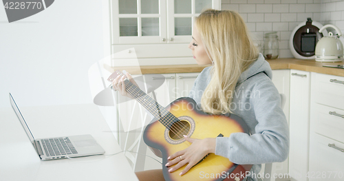 Image of Woman playing electric guitar