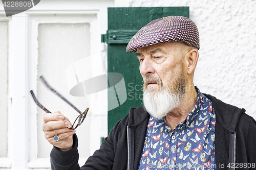 Image of an old man and his glasses