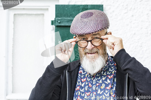 Image of an old man and his glasses