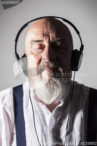 Image of an old man listening to music
