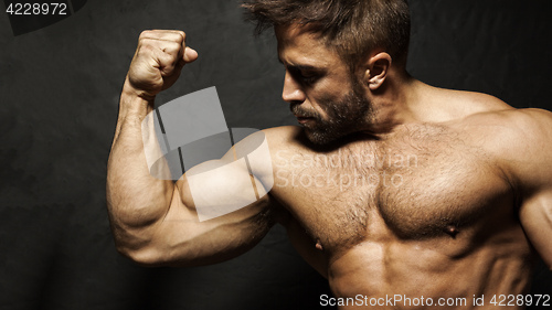 Image of A muscular man flexing his biceps