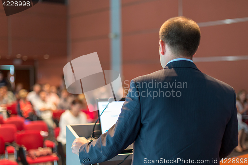 Image of Public speaker giving talk at Business Event.