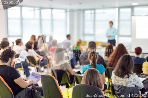 Image of Speaker giving presentation on business conference.
