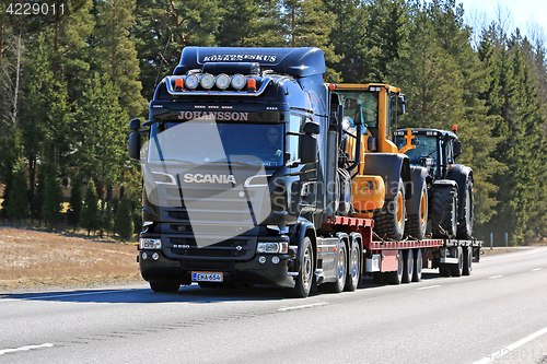 Image of Black Scania R520 Hauls Machinery along Road