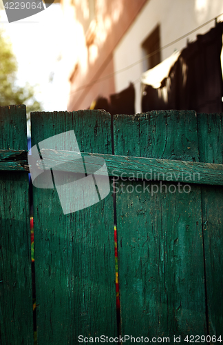 Image of Green wooden fence in residential district