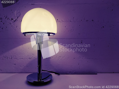 Image of Modern design table lamp near concrete wall