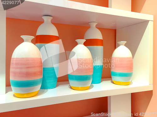 Image of Colorful ceramic vases on a shelf