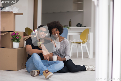Image of African American couple relaxing in new house