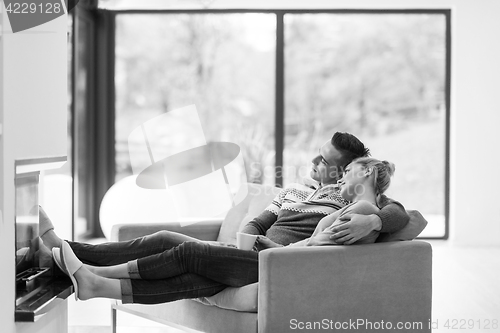 Image of Young couple  in front of fireplace