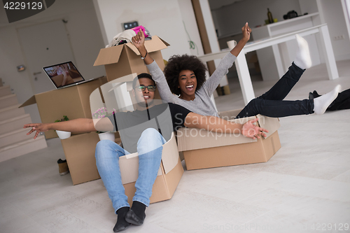 Image of African American couple  playing with packing material