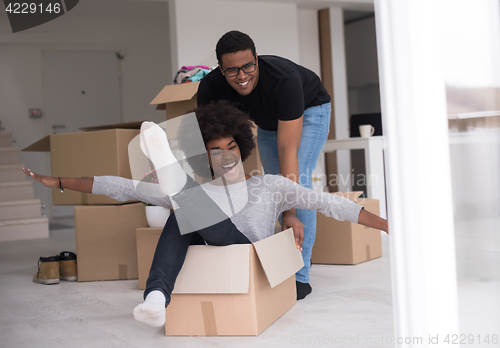 Image of African American couple  playing with packing material